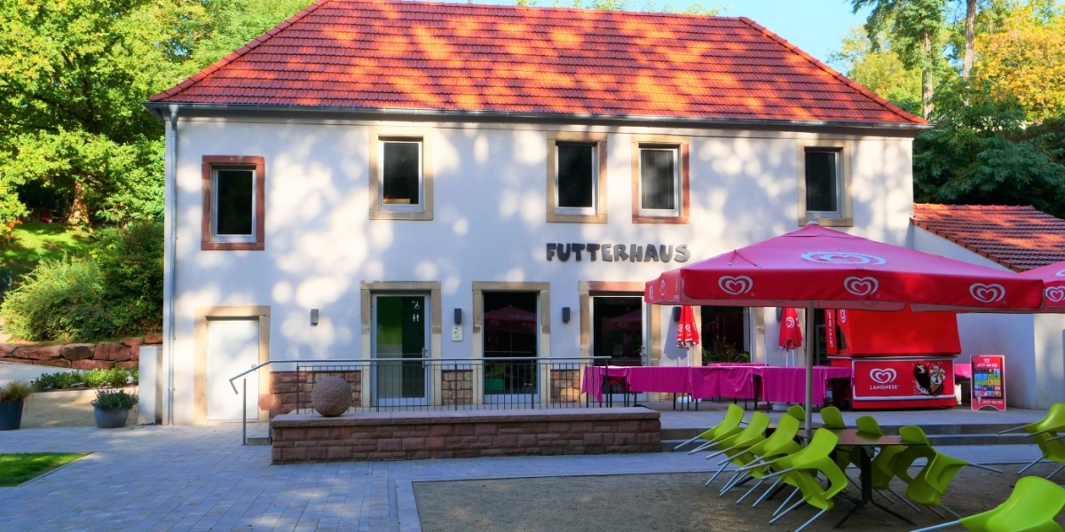 Futterhaus Das Bistro Futterhaus im Zoo mit Sitzmöglichkeiten ist zu sehen